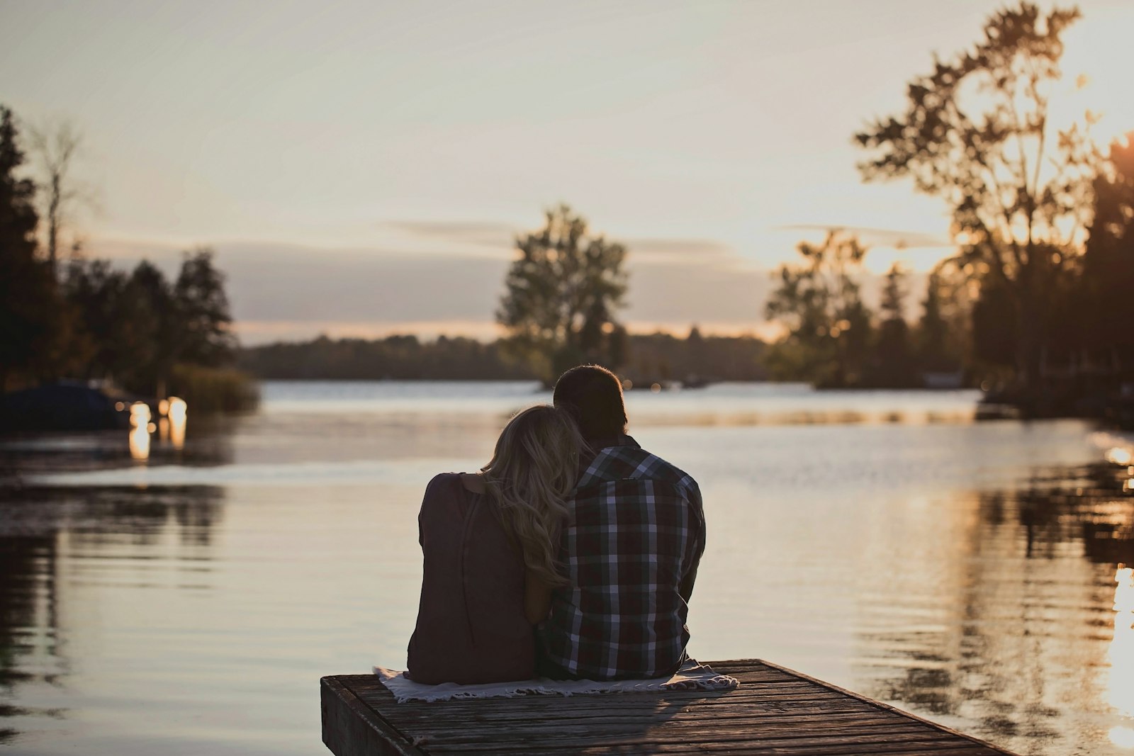 A couple sitting together at dusk, shot in moody black and white